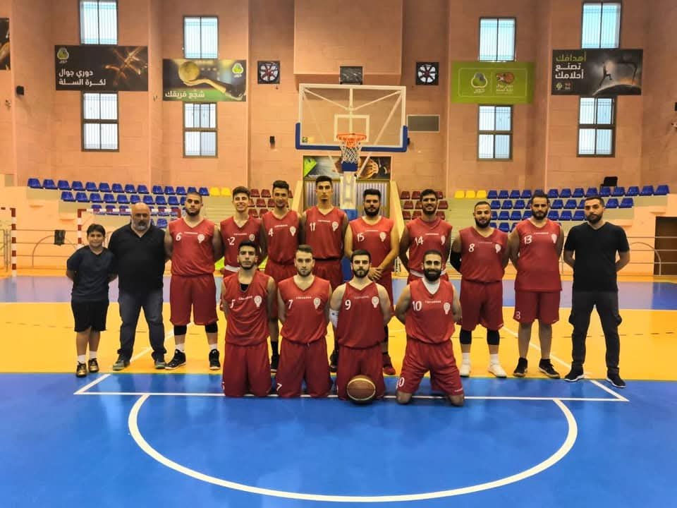 De La Salle basketball team assembled on an indoor court.